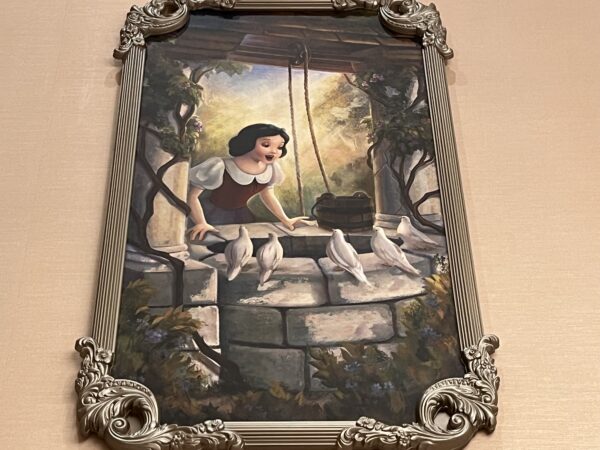 Snow White makes a wish at the well.
