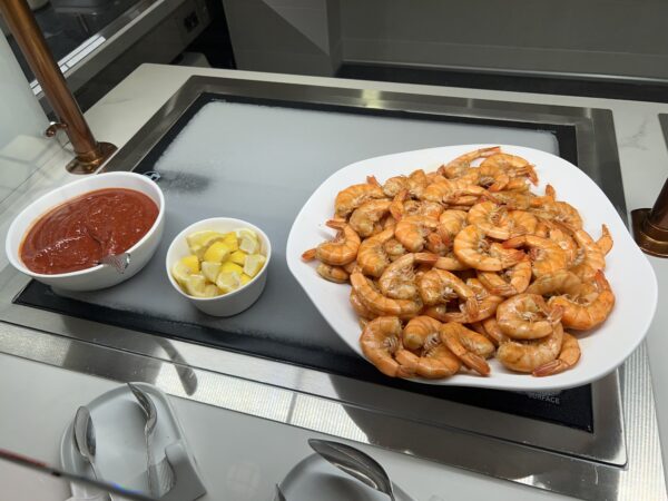 Peel and eat shrimp with lemon and cocktail sauce.