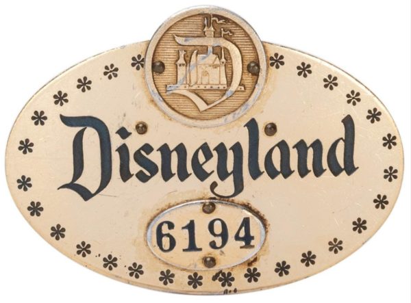 An early Disneyland cast member pin, is estimated at $1,000-2,000. This rarity measures 2 ½” long, dates from the 1950s, is numbered 6194, and has a unique oval design.