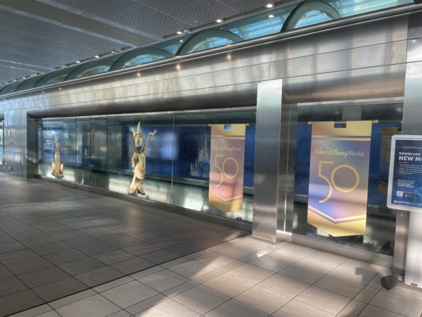 The windows of the tram stop on the air-side terminal are decorated with images of the same golden statues that can be found in Disney World!
