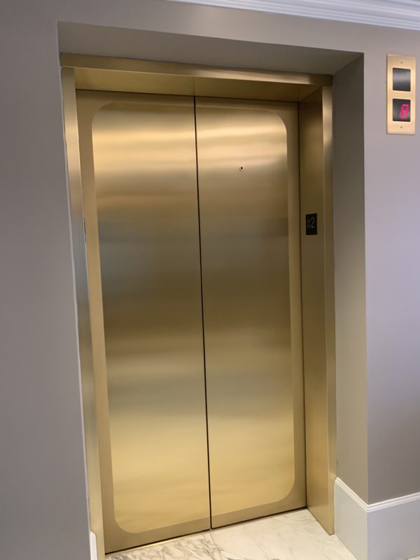 The gold elevator doors feel very high end.
