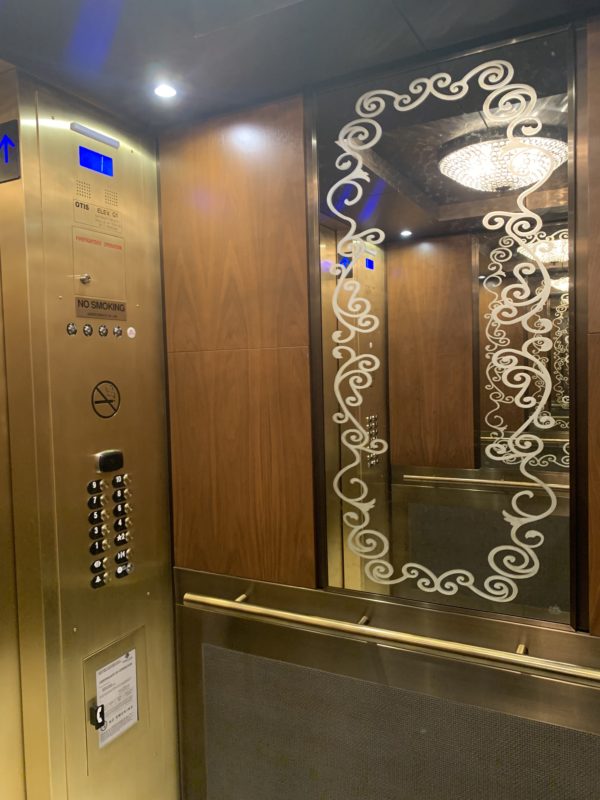 There are ornate mirrors inside the elevators too.