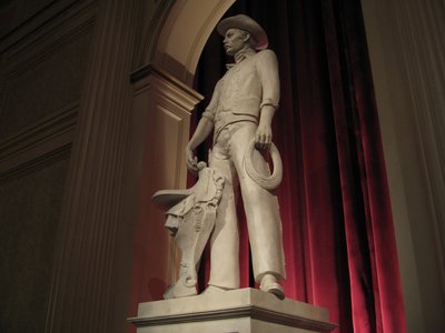 The statues in the theater that presents The American Adventure represent American values.