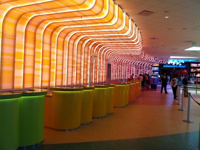 The check in desks are individual podiums instead of a long desk. This colorful area makes for more personal interactions.