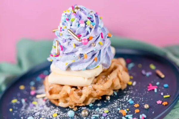 Celebration Funnel Cake with vanilla ice cream, whipped cream, sprinkles and candles. Available Oct. 1 and 2. Funnel Cake. Photo Credit © Disney Enterprises, Inc. All Rights Reserved.
