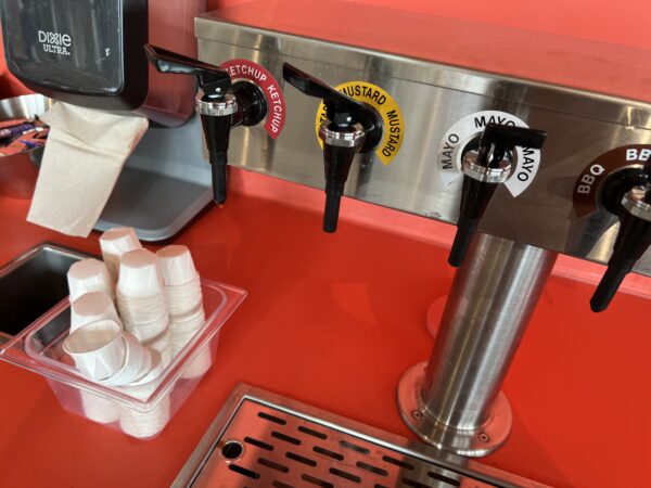 You can get condiments in small paper cups instead of plastic packets.