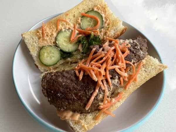 The carrots and cucumbers, together with sauce, gave this hamburger a great taste.