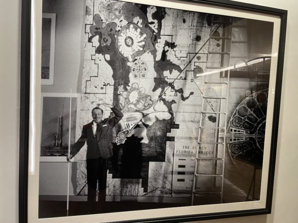 Photo of Walt standing in front of a map of The Florida Project.