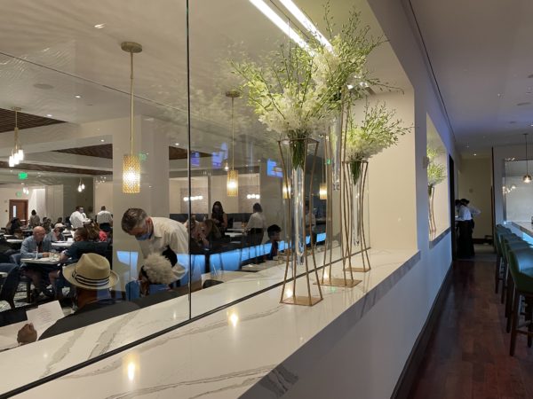 Large windows connect the bar and the dining room. 