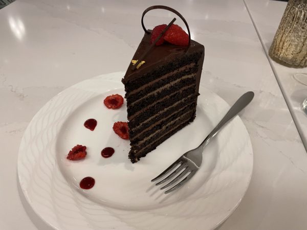 The chocolate cake has layers and layers and layers - with raspberries and a touch of gold.