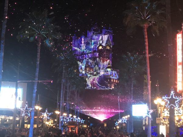 Holiday projections bring the Tower of Terror to life with Christmas scenes.