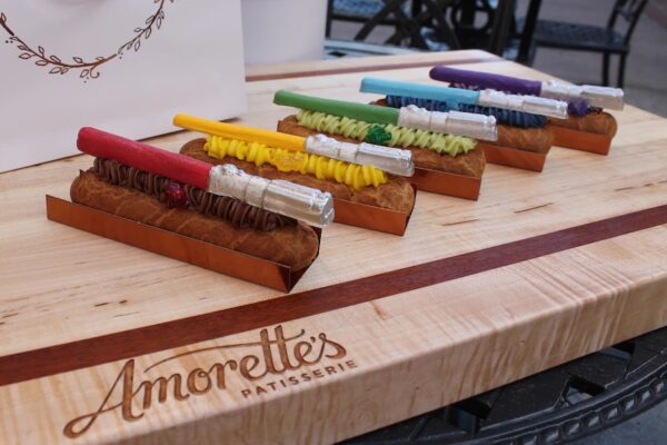 Disney Springs. Amorette’s Patisserie (available May 4 through 8). Lightsaber Eclairs: Flavors include Mace Windu berry cherry, Master Yoda pistachio, Rey passion pineapple, Darth Vader Dark Side mousse flavored with cayenne pepper and cinnamon, and Obi Wan Kenobi blue matcha. Photo credits (c) Disney Enterprises, Inc. All Rights Reserved