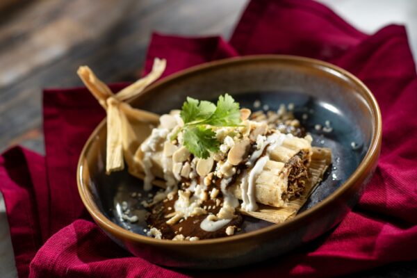 Plant-based Chorizo Tamale with plant-based cotija and spicy red chile sauce (Plant-based)