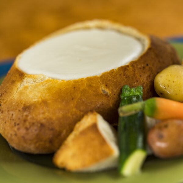Cheese Fondue in a bread bowl with steamed baby vegetables and marble potatoes