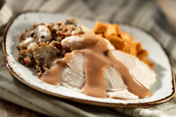 Dinde Rôtie, Sauce et Garniture, servi avec Patates Douces: Roasted turkey with mushrooms, pearl onions, bacon, turkey gravy, and roasted sweet potatoes (New)