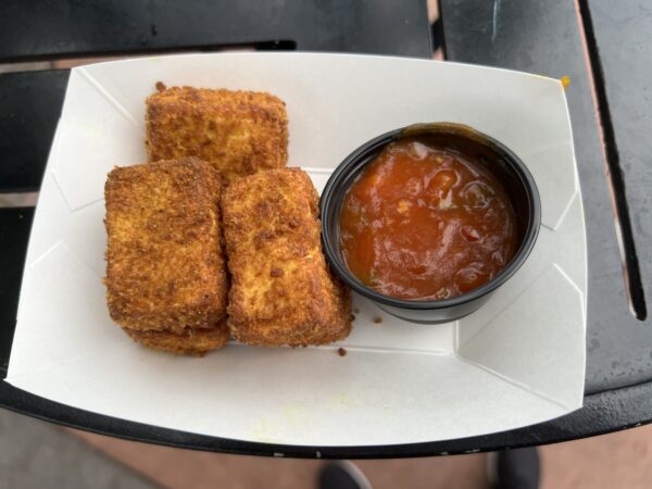 The paneer was served warm. The ketchup added some spice and flavor.