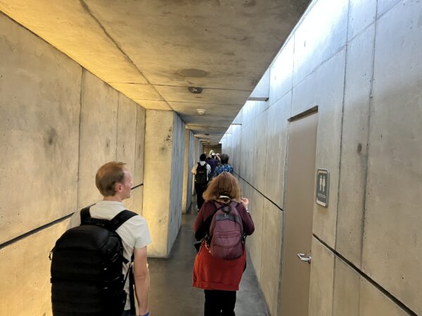 After you enter the building, you head down a long hallway where you will leave earth behind.