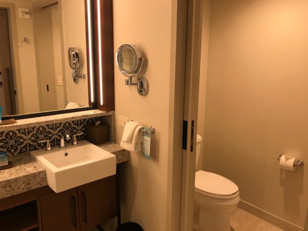The room features two sinks and a water closet that separates by a pocket door.