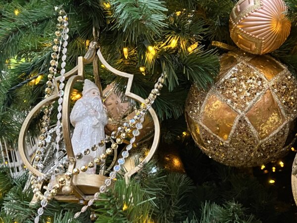 Victorian decorations adorn the tree, including Father Christmas.