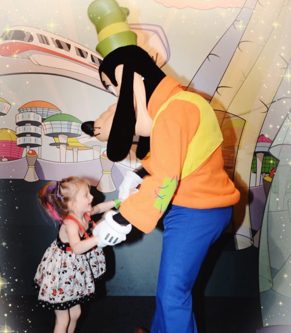 Our daughter, Hailey, living in the moment and dancing with Goofy.