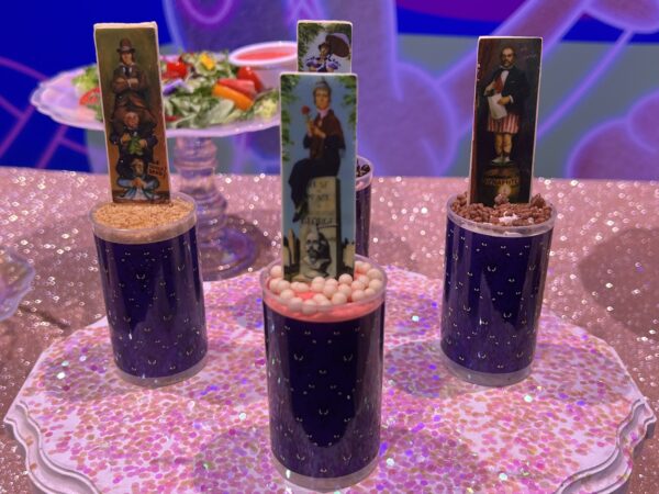 Chilling Chamber Pops. Lady on the Gravestone – citrus cake crumbs, raspberry buttercream, and blue crisp pearls. Available at Sleepy Hollow