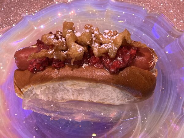 50th Celebration Hot Dog. All beef hotdog topped with strawberry-bacon jam, crisp funnel cake pieces, and powdered sugar. Available at Casey’s Corner