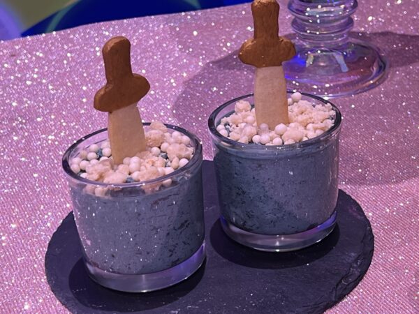 The Sword In The Sweet Dessert. Cookies 'n cream cheesecake mousse with chocolate cookie crumble topped with crispy pearls in a cookie sword. Available at Cinderella‘s Royal Table