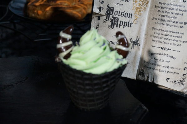 This Maleficent Dessert made with lime soft serve ice cream in a black waffle cone and topped with chocolate horns is available at Storybook Treats in Fantasyland!