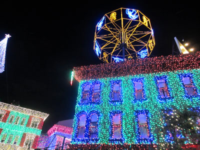 The buildings are covered with lights.