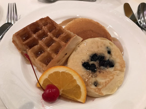 Waffles, pancakes, pastries, and fruit are all included on the breakfast menu.