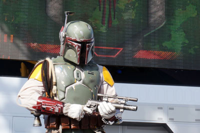 Boba Fett, the bounty hunter, keeps an eye on the crowd.