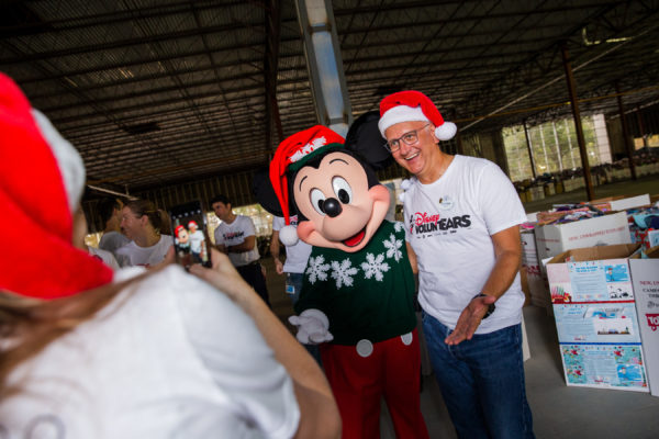 Toys for Tots VoluntEAR poses with Mickey Mouse