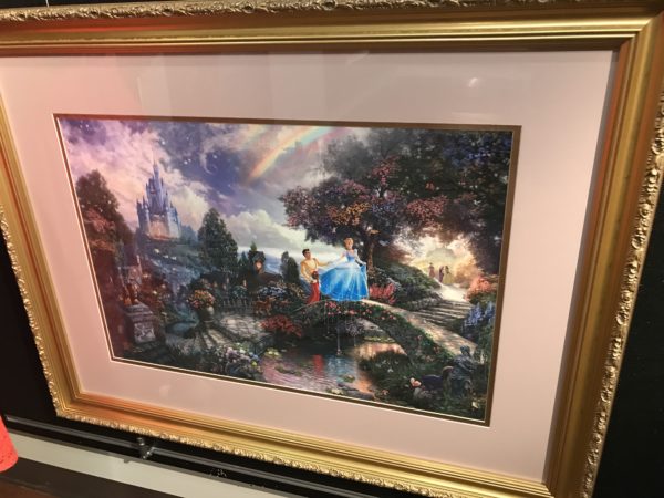 Cinderella and Prince Charming wander through a beautiful garden with the castle in the background in this beautiful painting.